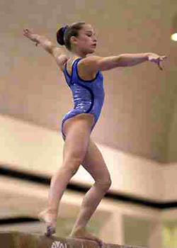 A young female olympic performer dressed in a highly immodest one-piece