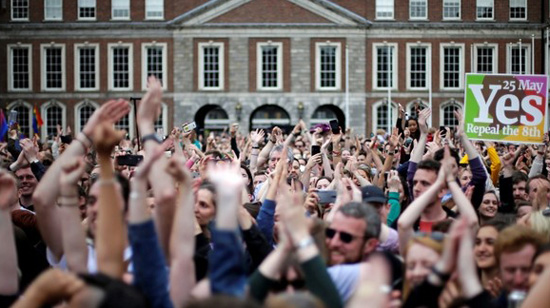 pro abortion voters waving and screaming in Dublin