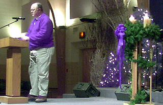 A colorfully dressed priest leads a 'reconciliation service'