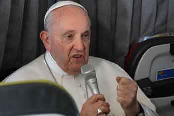 Pope Francis speaking into a microphone