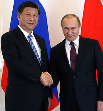 Putin and Xi Jinping shaking hands