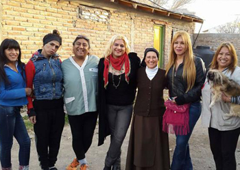 sister monica standing in a parking lot with her arms around male-to-female transgenders