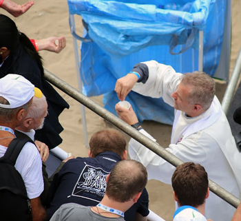 Communion distributed from paper cups at the Rio WYD