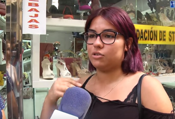 A woman in a black tanktop being interviewed defends the Ganesh statue entering the sanctuary