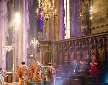 Dalai Lama seated in the choir presbytery in St. Stephen's Cathedral